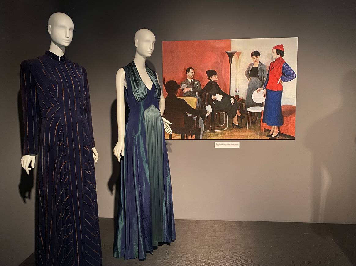 Artwork depicting Elizabeth Hawes at work in her color blocked studio with her dresses next to it.