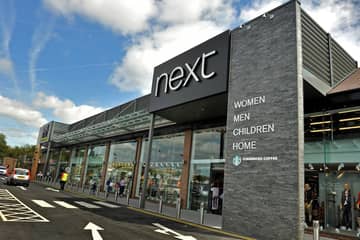 Next posts H1 loss but raises profit outlook on strong trading