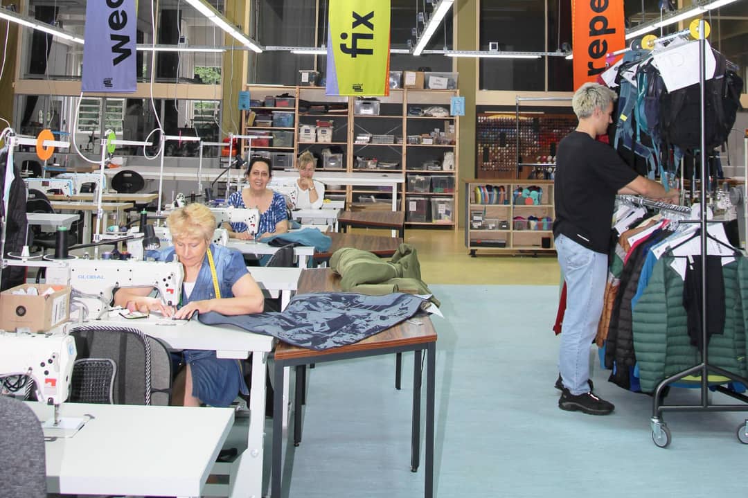 Image: Halyna, Hengameh, Anna, and Ton repair clothing at the new, larger United Repair Centre location in Amsterdam-West.