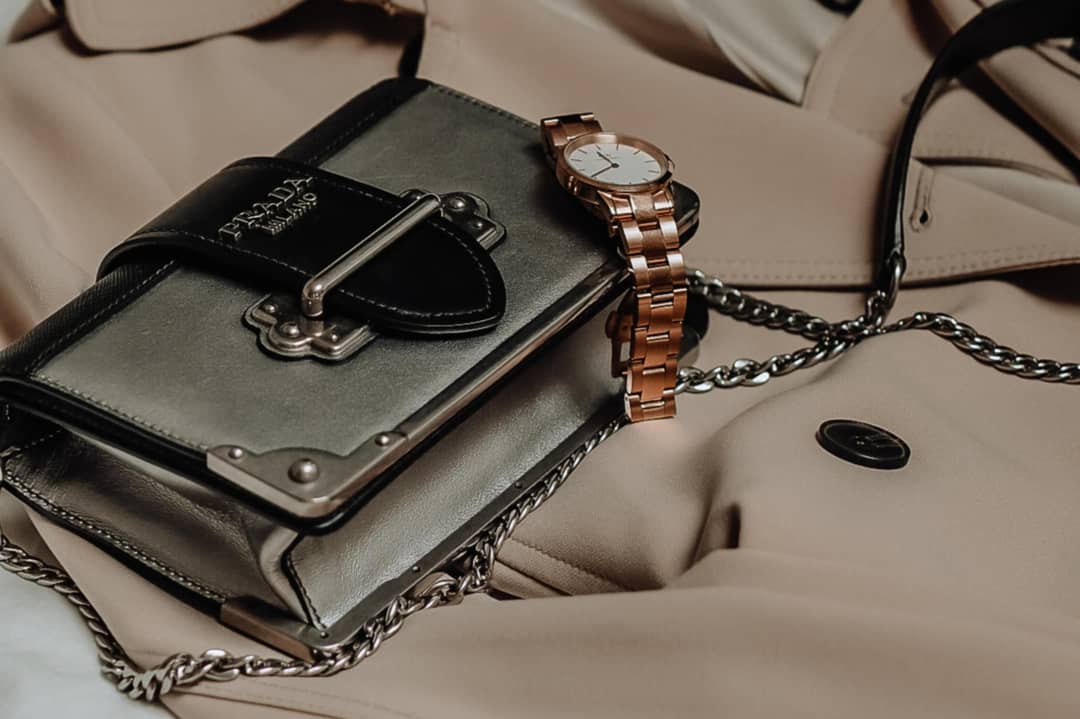 Prada handbag, luxury trench coat and watch
