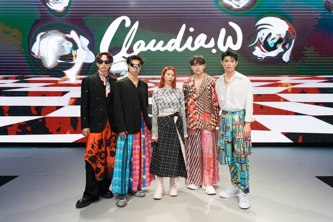 Claudia W with boyband FEniX at her AW24 show.