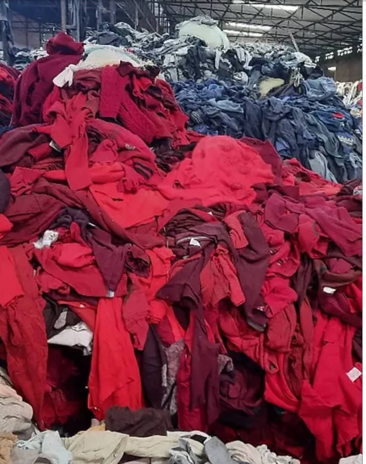 Piles of color sorted textile waste at Wastewear plant