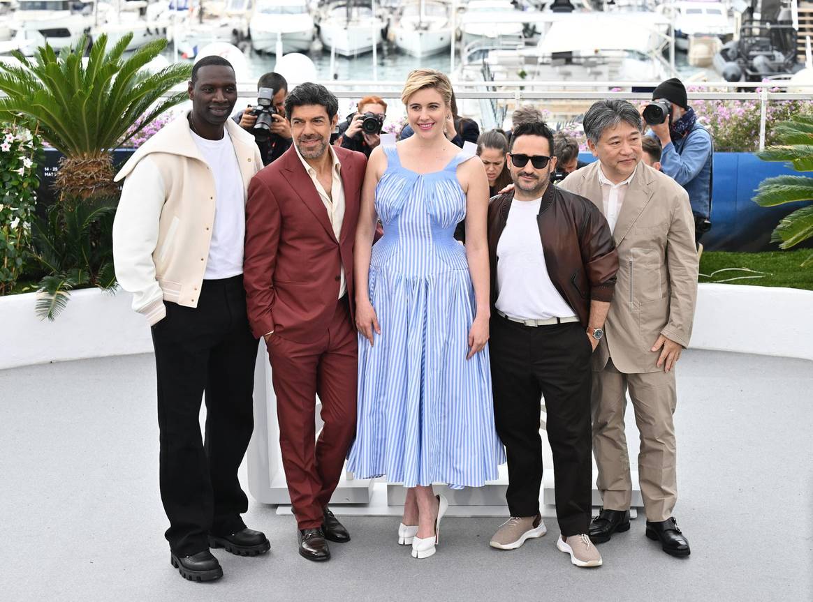 77th Cannes Film Festival jury: Greta Gerwig in Margiela, Juan Antonio Bayona in Berluti, Pierfrancesco Favino, Hirokazu Kore-eda and Omar Sy.