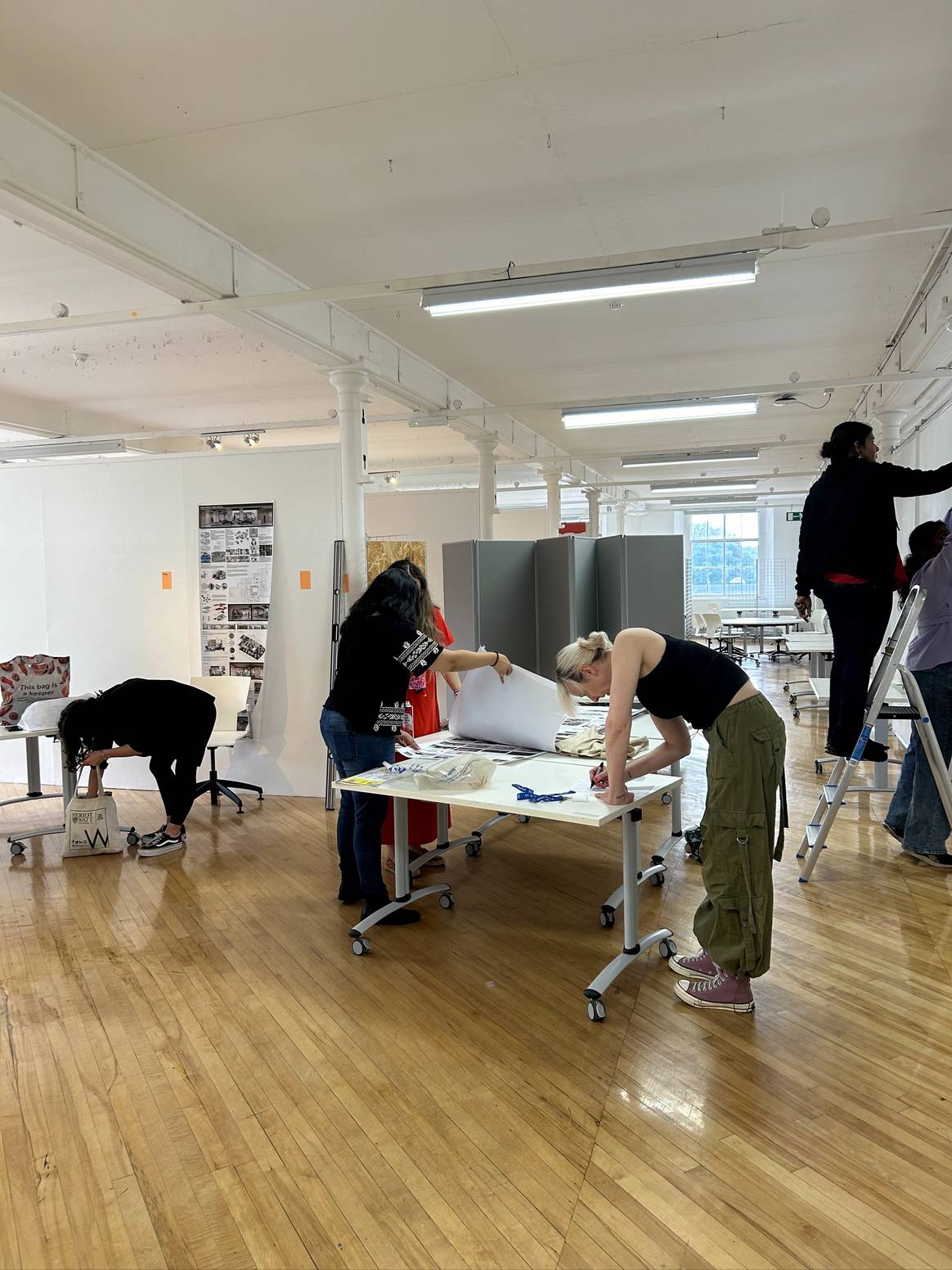 Students setting up their work for the master degree show at Heriot-Watt's High Mill building.